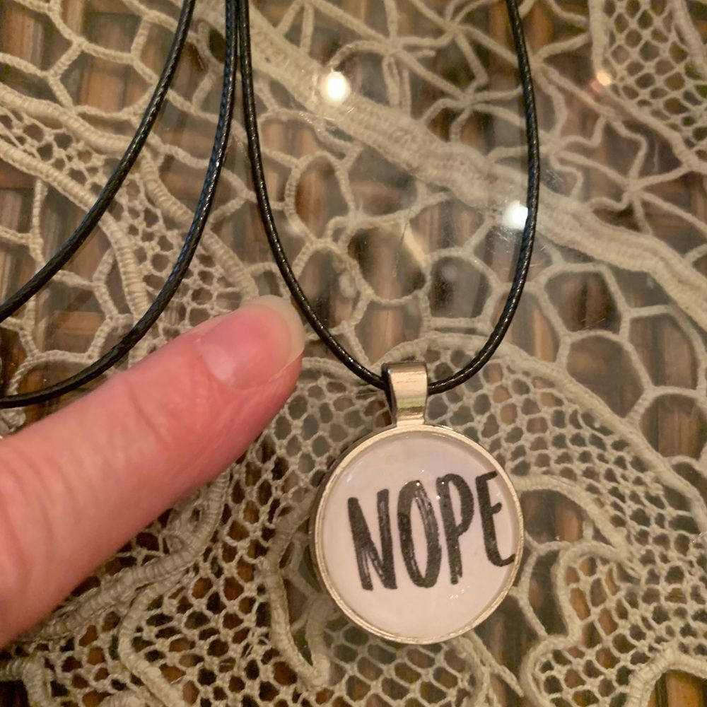 That’s a NOPE for me! silvertone pendant on vegan leather cord